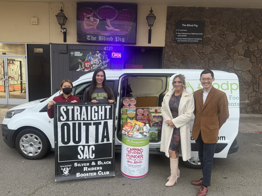 The fully filled ASI Food Pantry van and donation barrel with staff smiling.